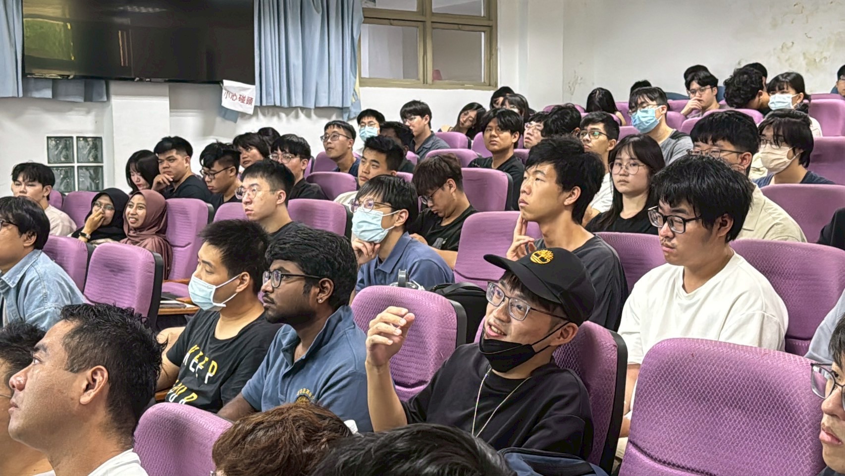 The students are attentively listening to the lecture