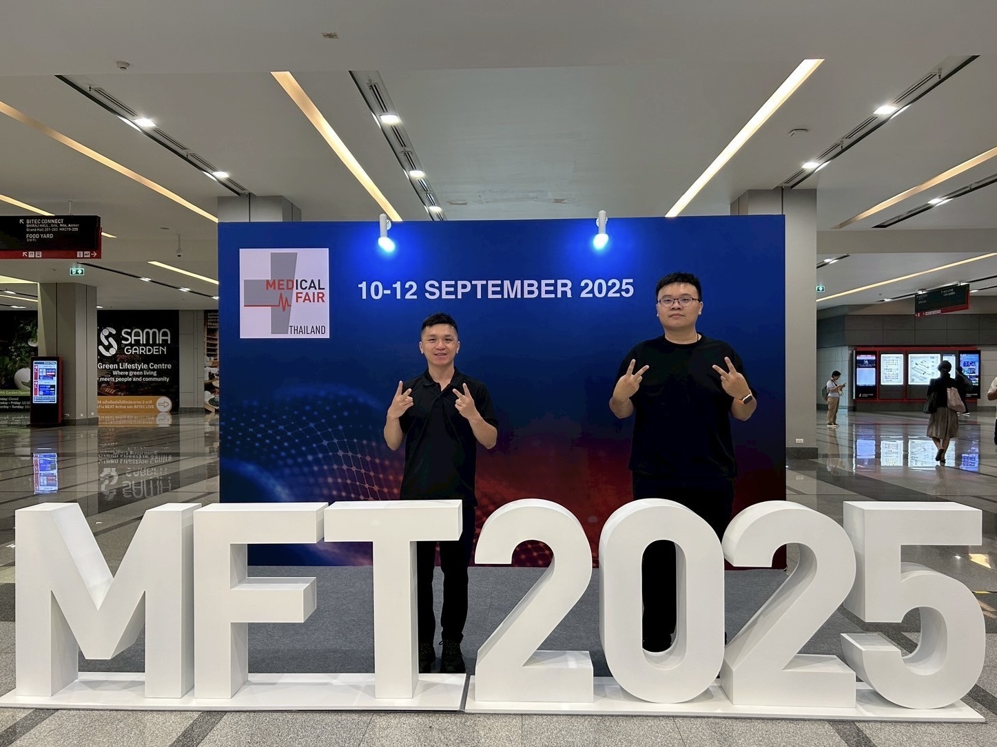 Dr. Yu-Cheng Chang and Dr. Shih-Hao Huang pose for a photo with the event signage