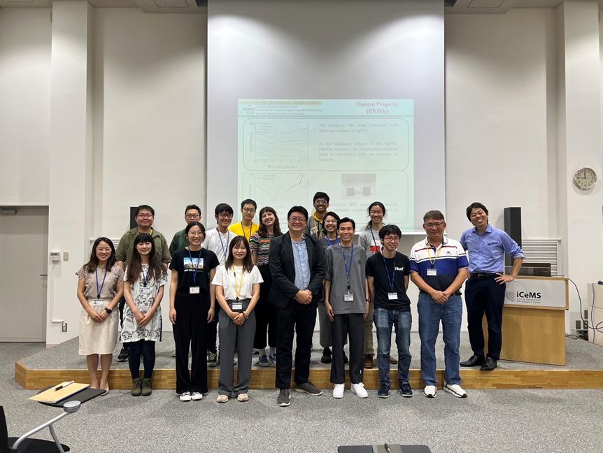 Professors and students pose for a group photo together.
