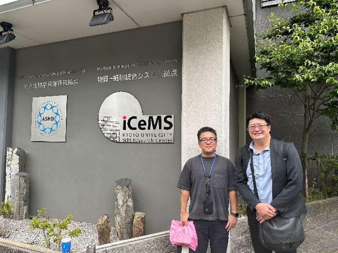 Professor Shuhei Furukawa and Professor Ren-Jei Chung pose for a photo in front of the entrance to the laboratory in Japan.
