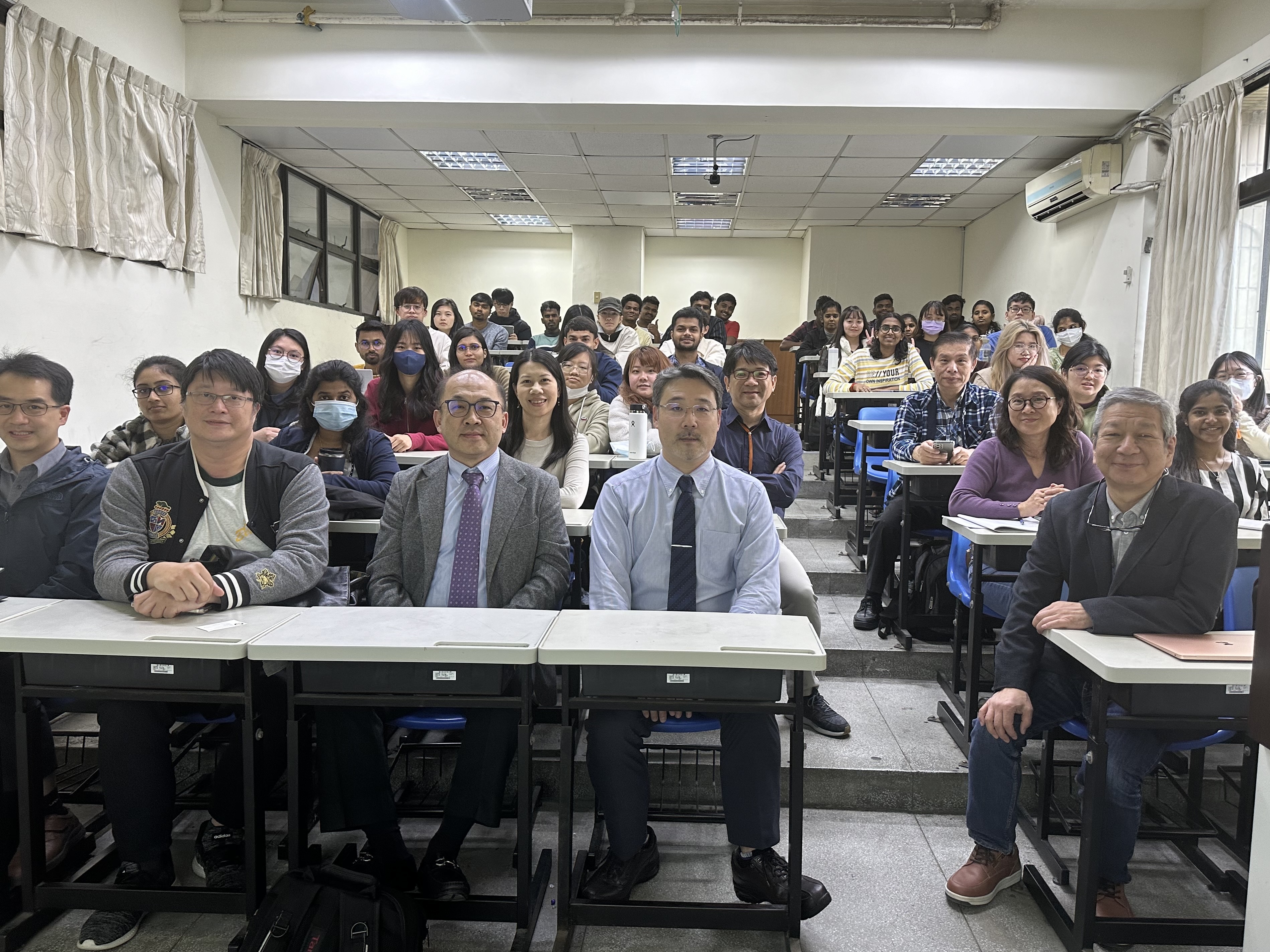 Professor Akira Matsumoto poses for a group photo with faculty members and students.