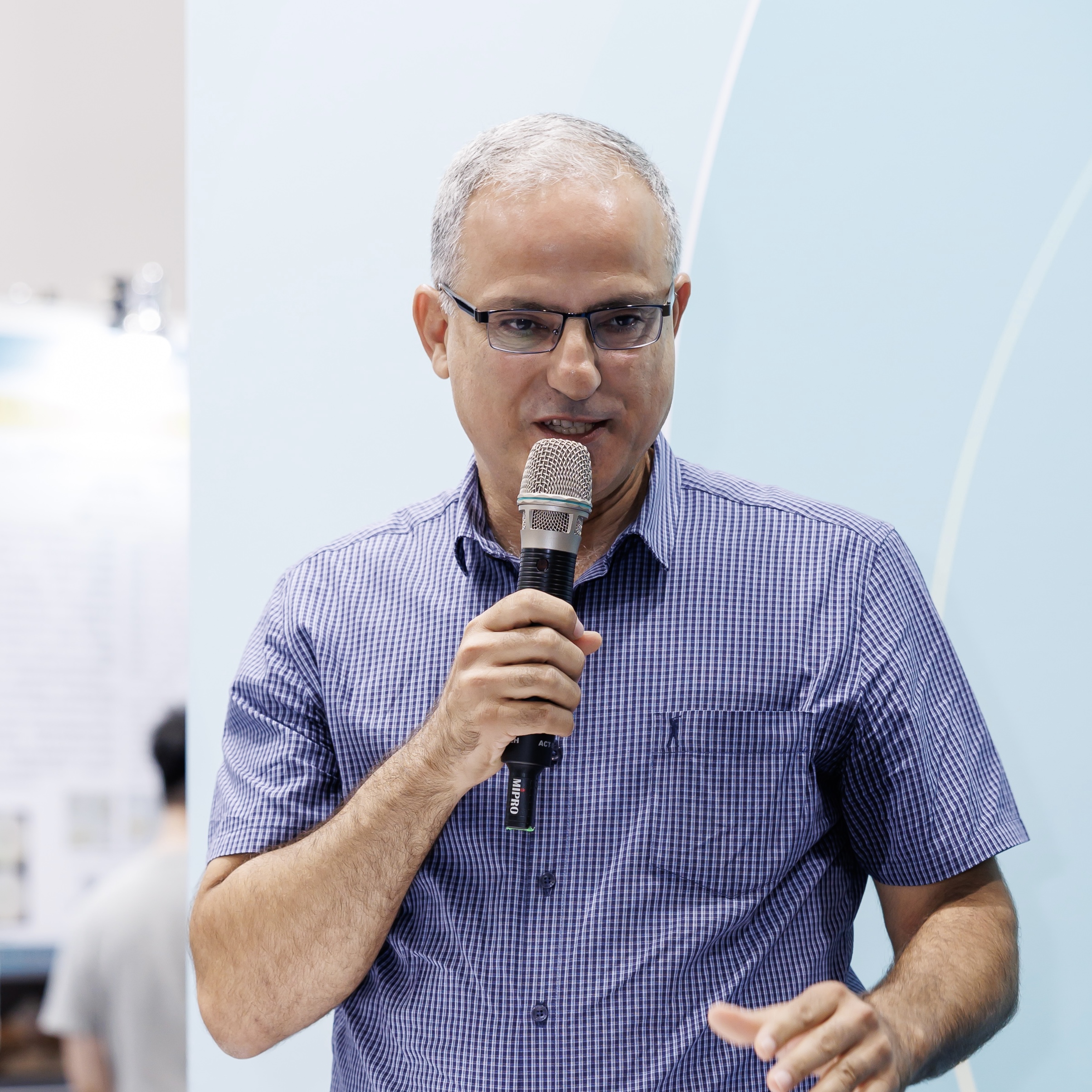 Speaker sharing experiences and insights on stage 01.
