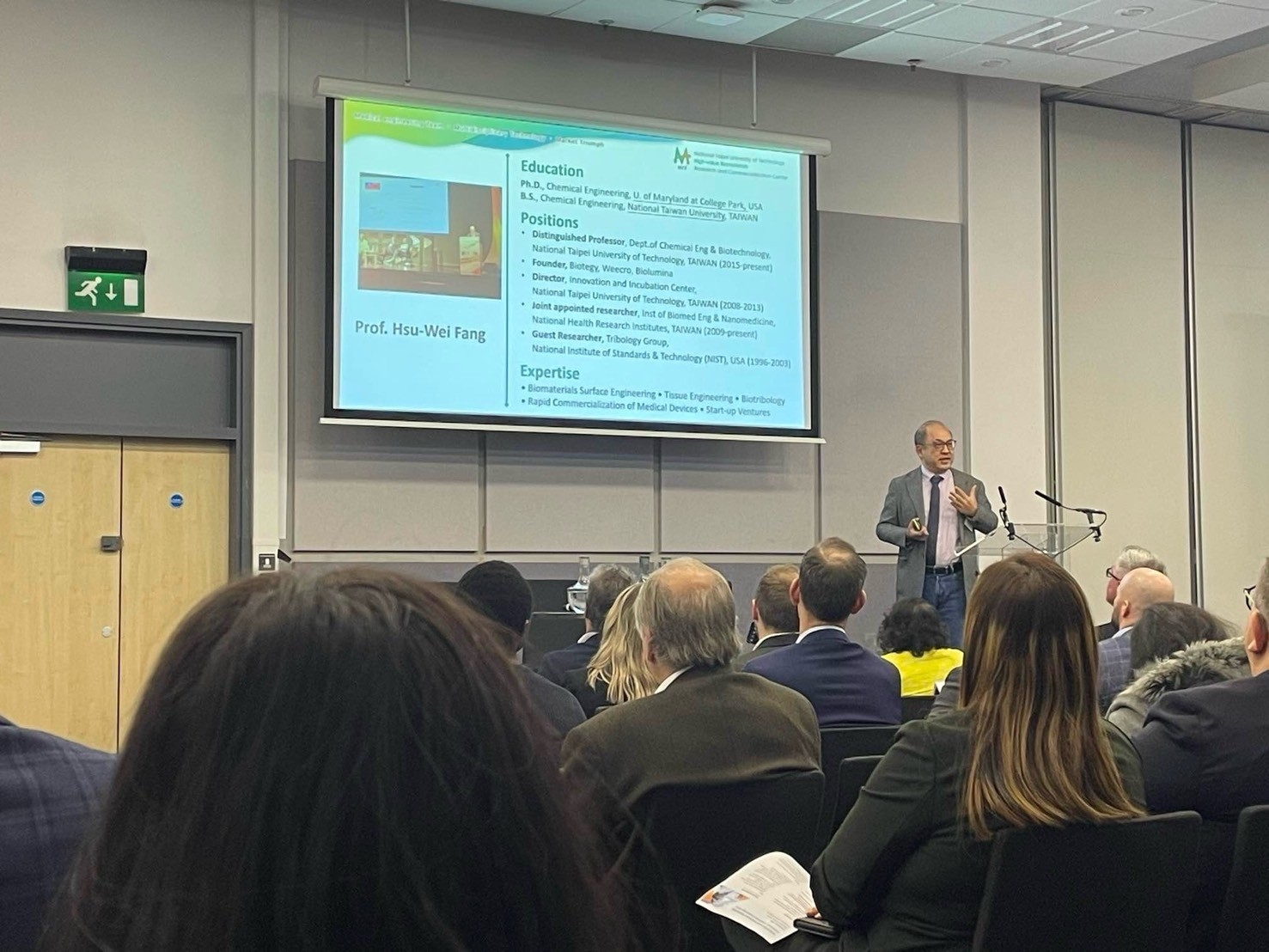 Professor Hsu-Wei Fang delivers a keynote presentation on stage 02.