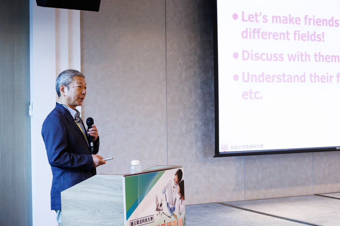 Prof. Yukio Nagasaki is giving a presentation on stage